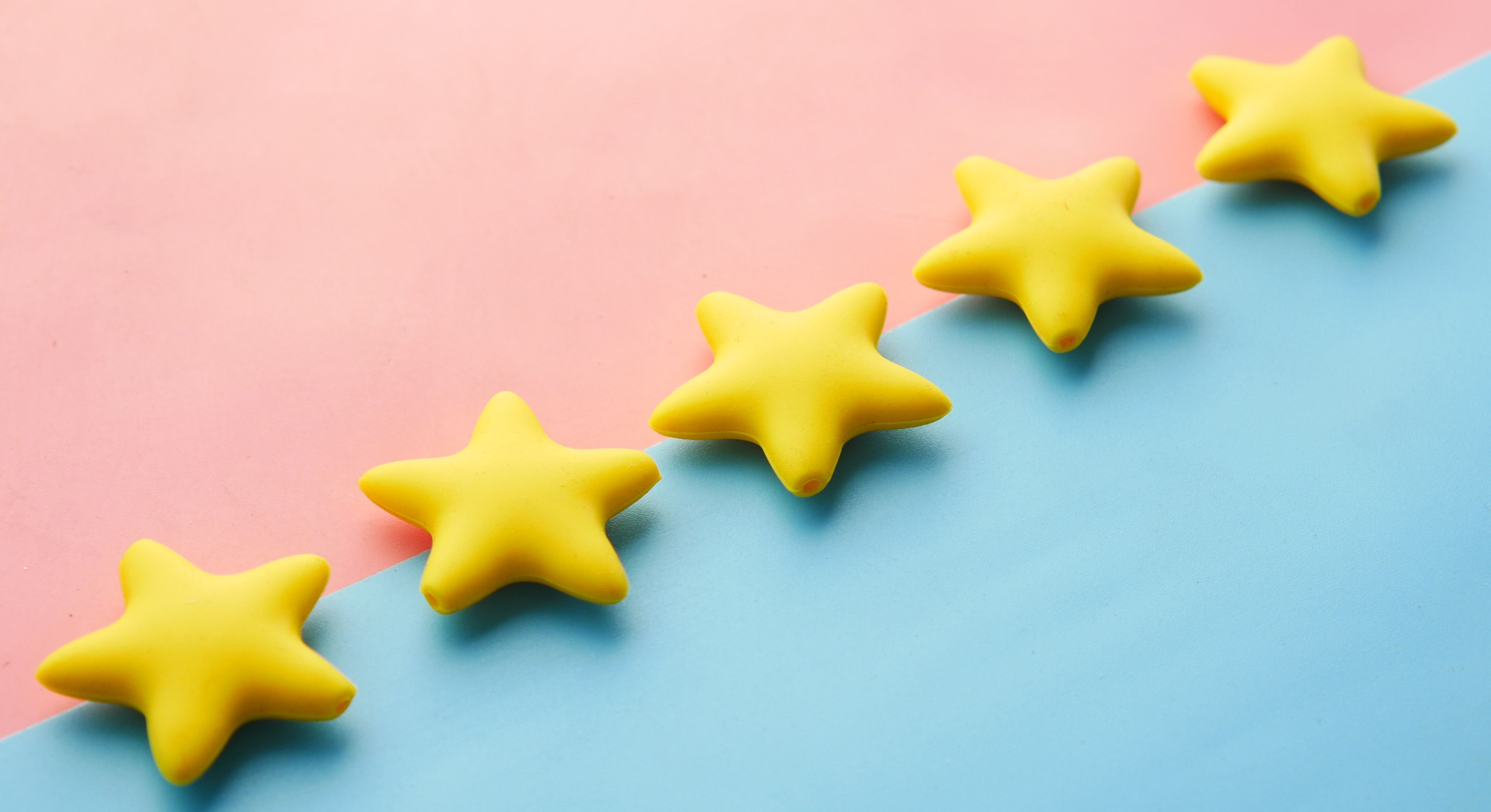 digital graphic of 5 stars in a line on a blue and pink background