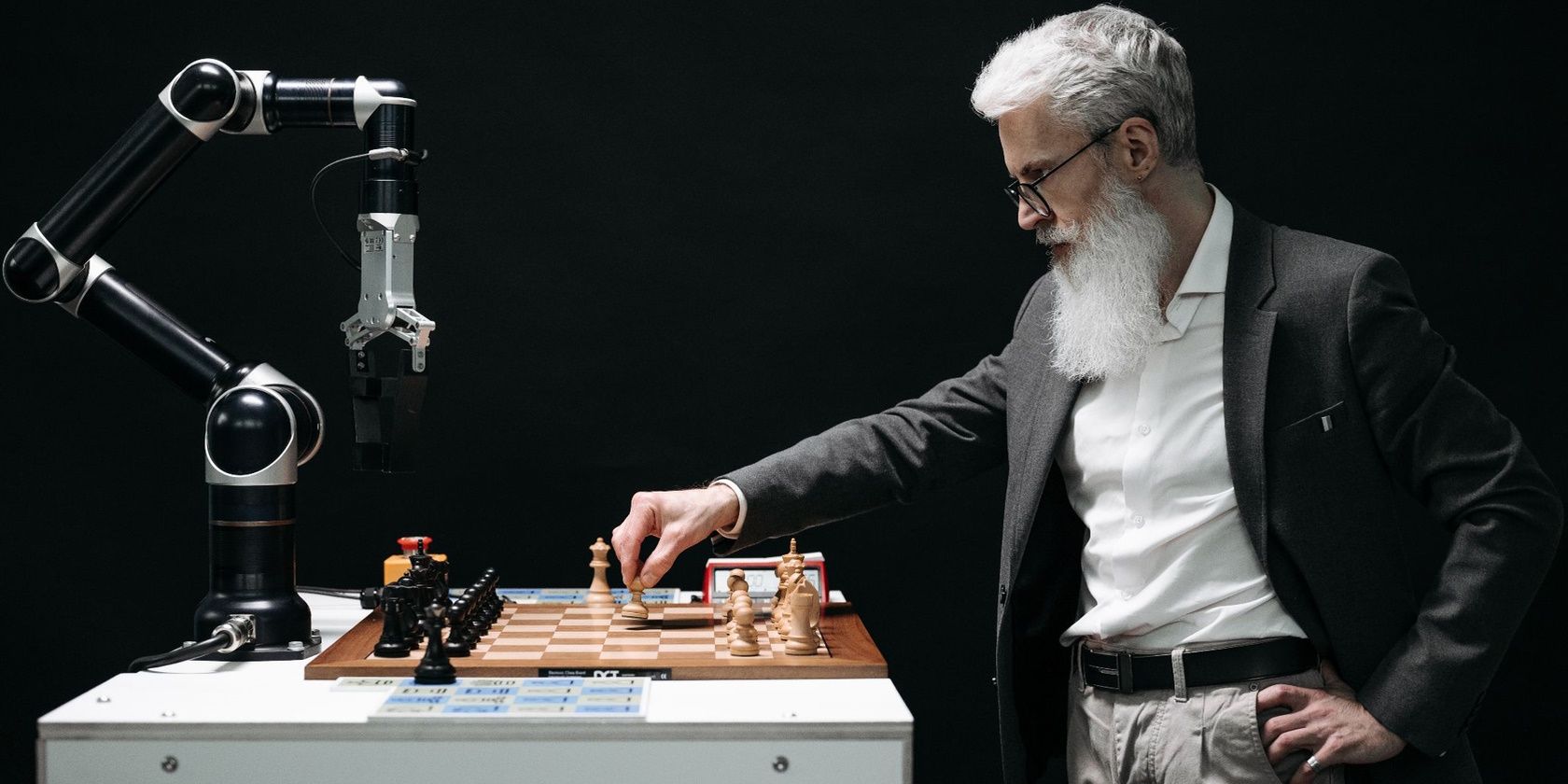 A man playing a chess game with an Artificial Intelligence robot