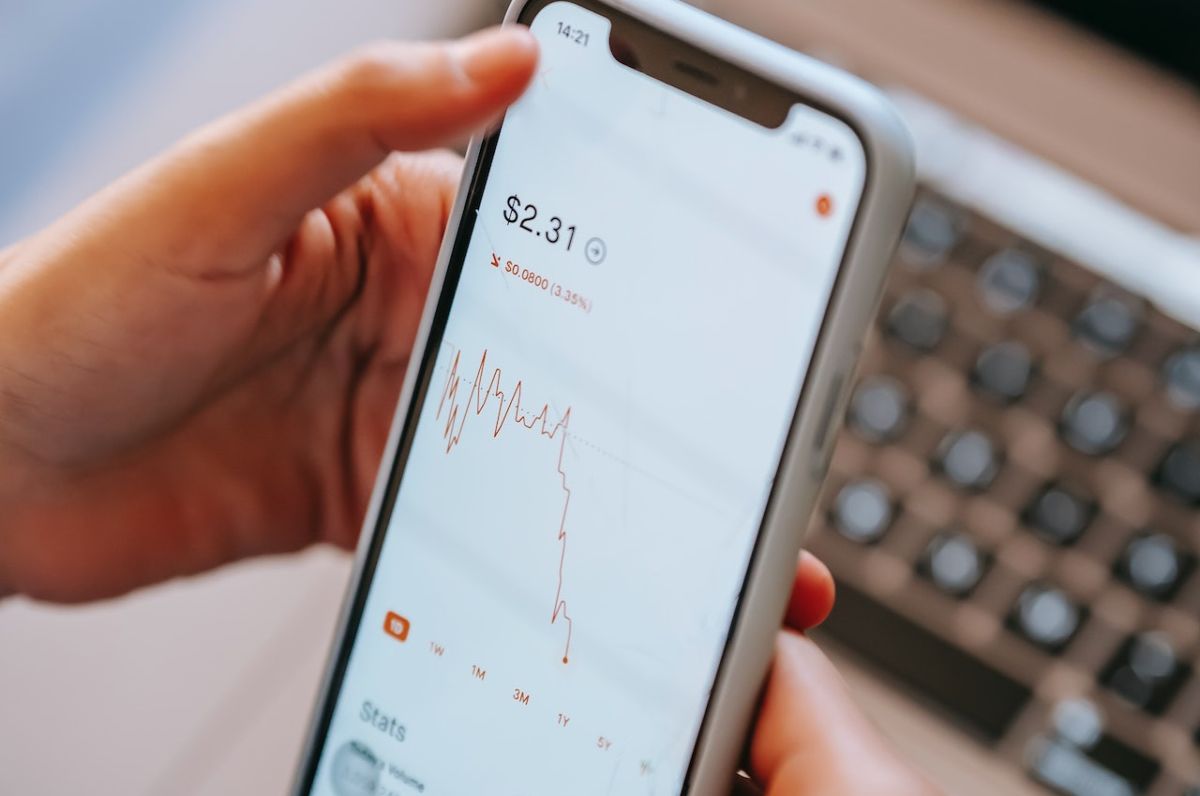 a phone showing a falling financial chart
