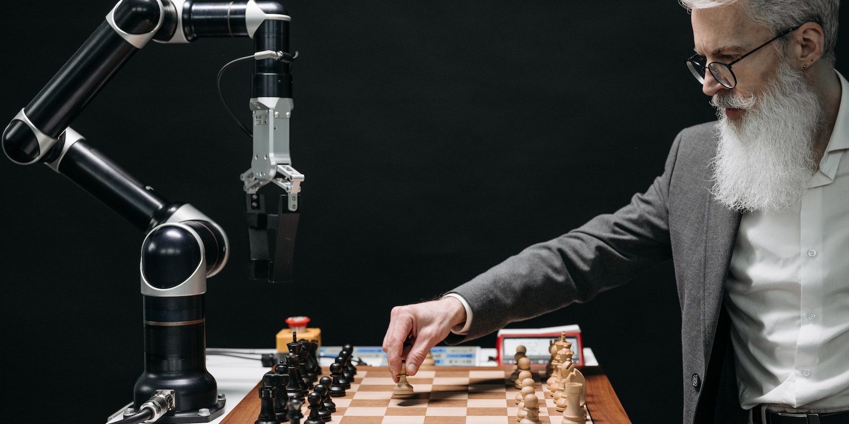 bearded man playing chess with robot