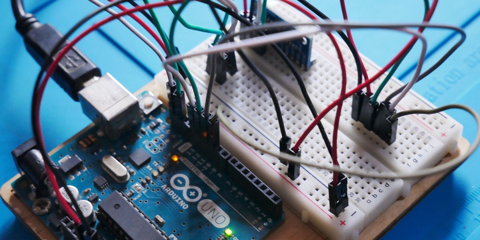 An Arduino Uno board wired to a couple of sensors on a breadboard.