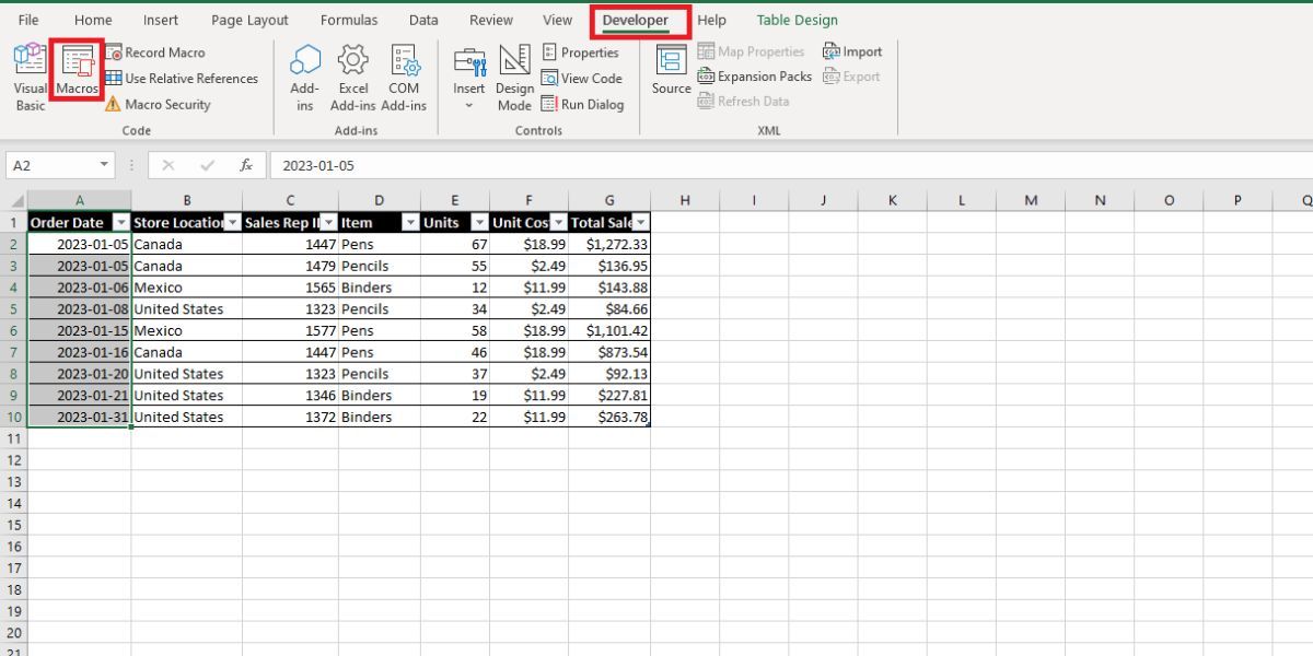 Excel ribbon with developer tab selected and red box around Macros feature on far left