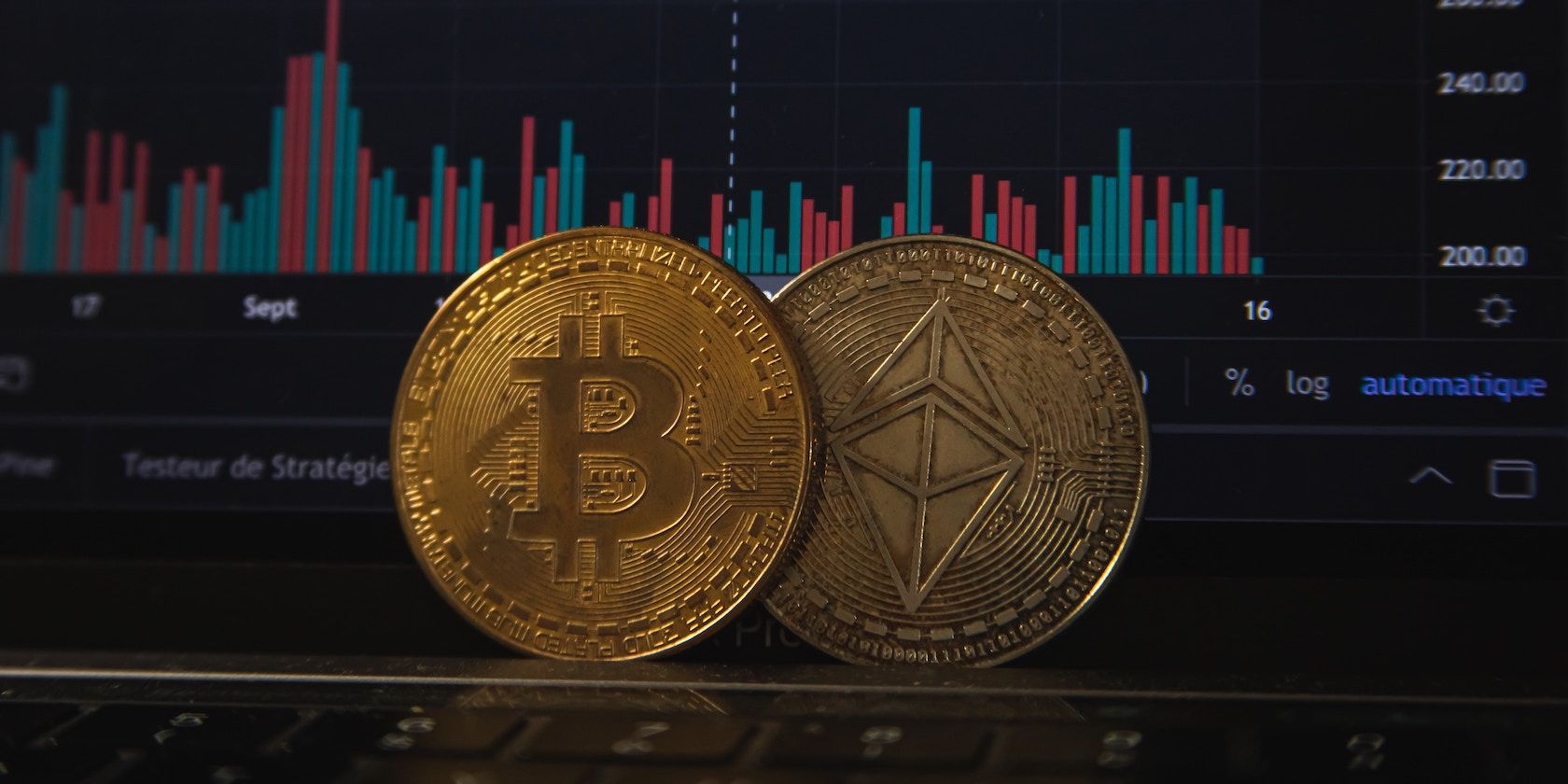 Bitcoin and ethereum coins in front of a trading graph