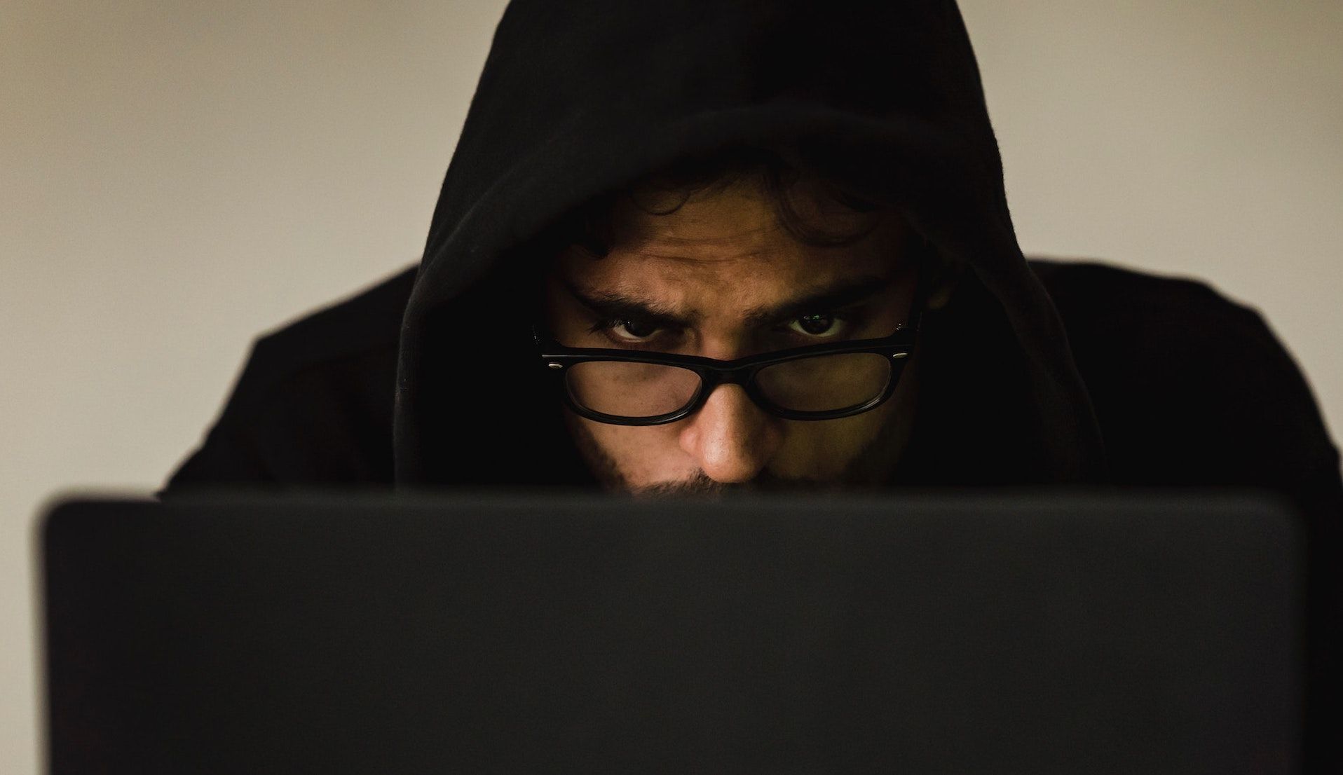 Man in a Hoodie Working on a Computer