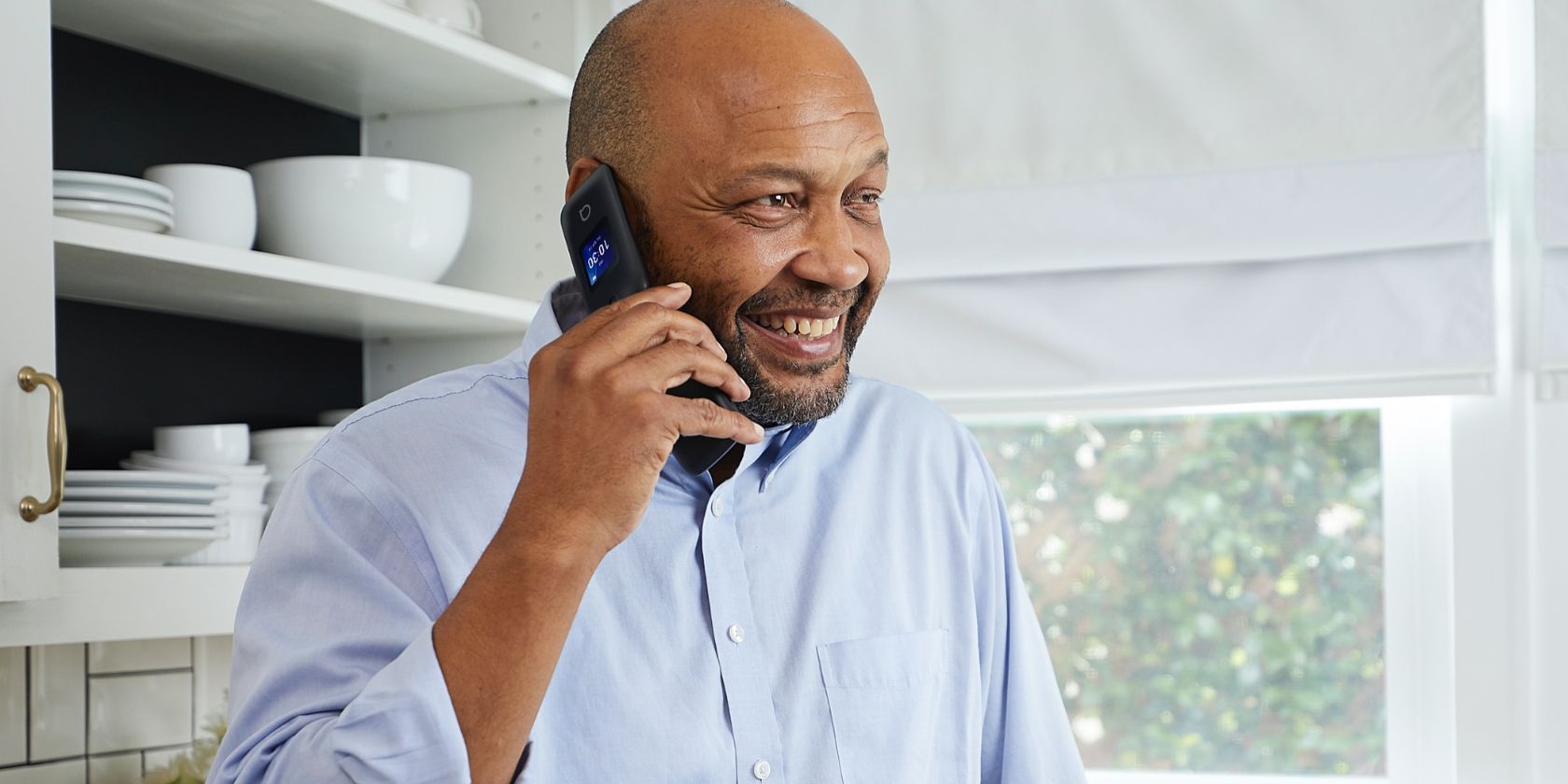 Man talking on a Alcatel GO FLIP 4 cellphone