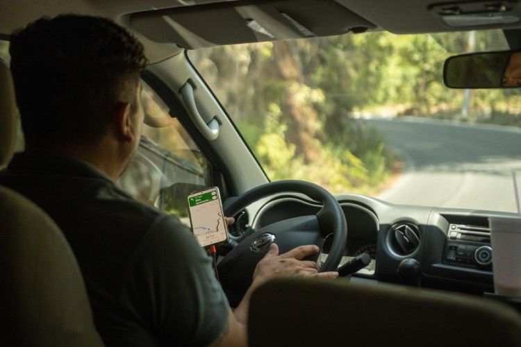 Man using Maps when driving his car
