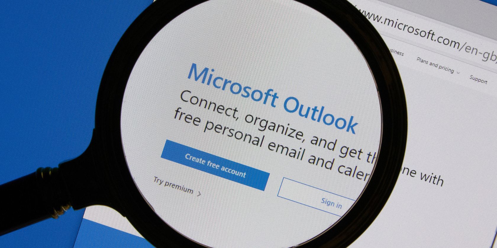 microsoft outlook login page being looked at with magnifying glass
