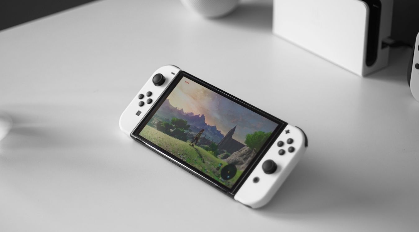 A photograph of a Nintendo Switch OLED console in handheld mode 