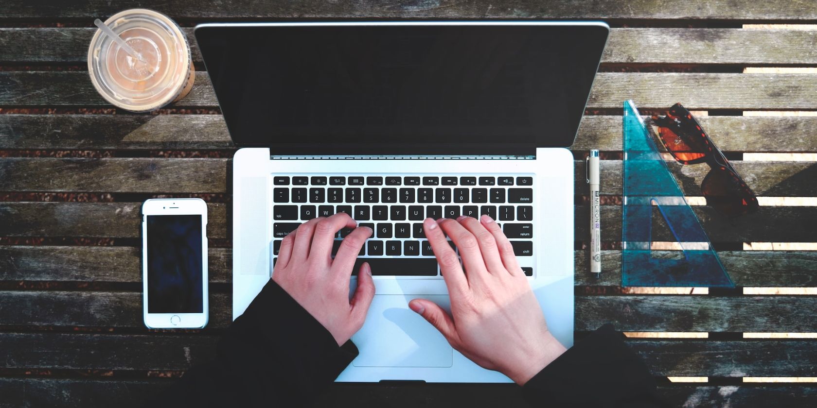 person typing on a MacBook keyboard