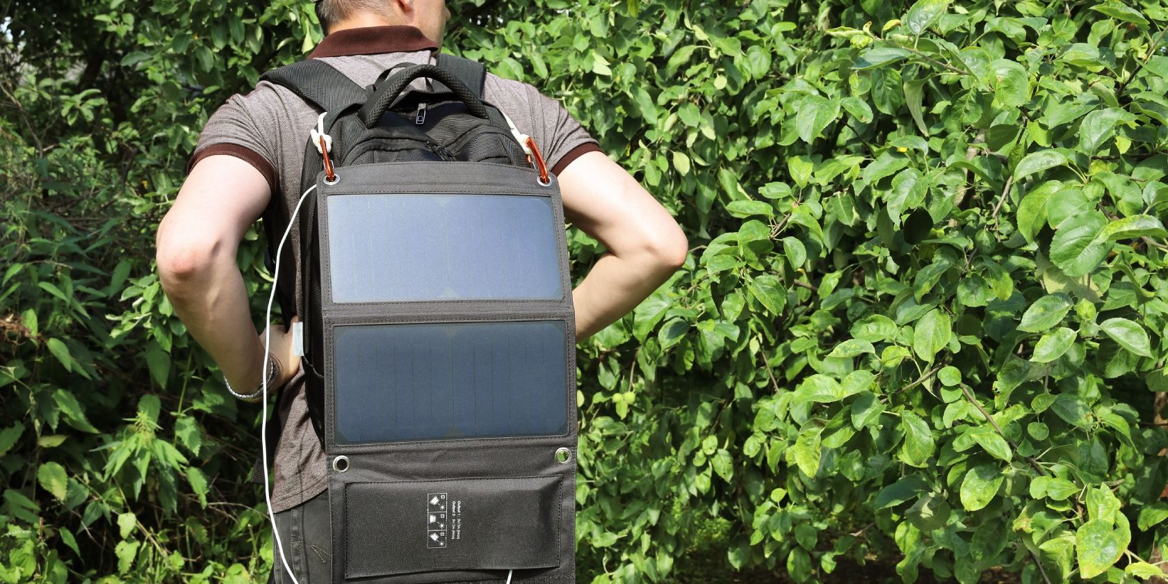Person wearing a solar panel backpack outdoors