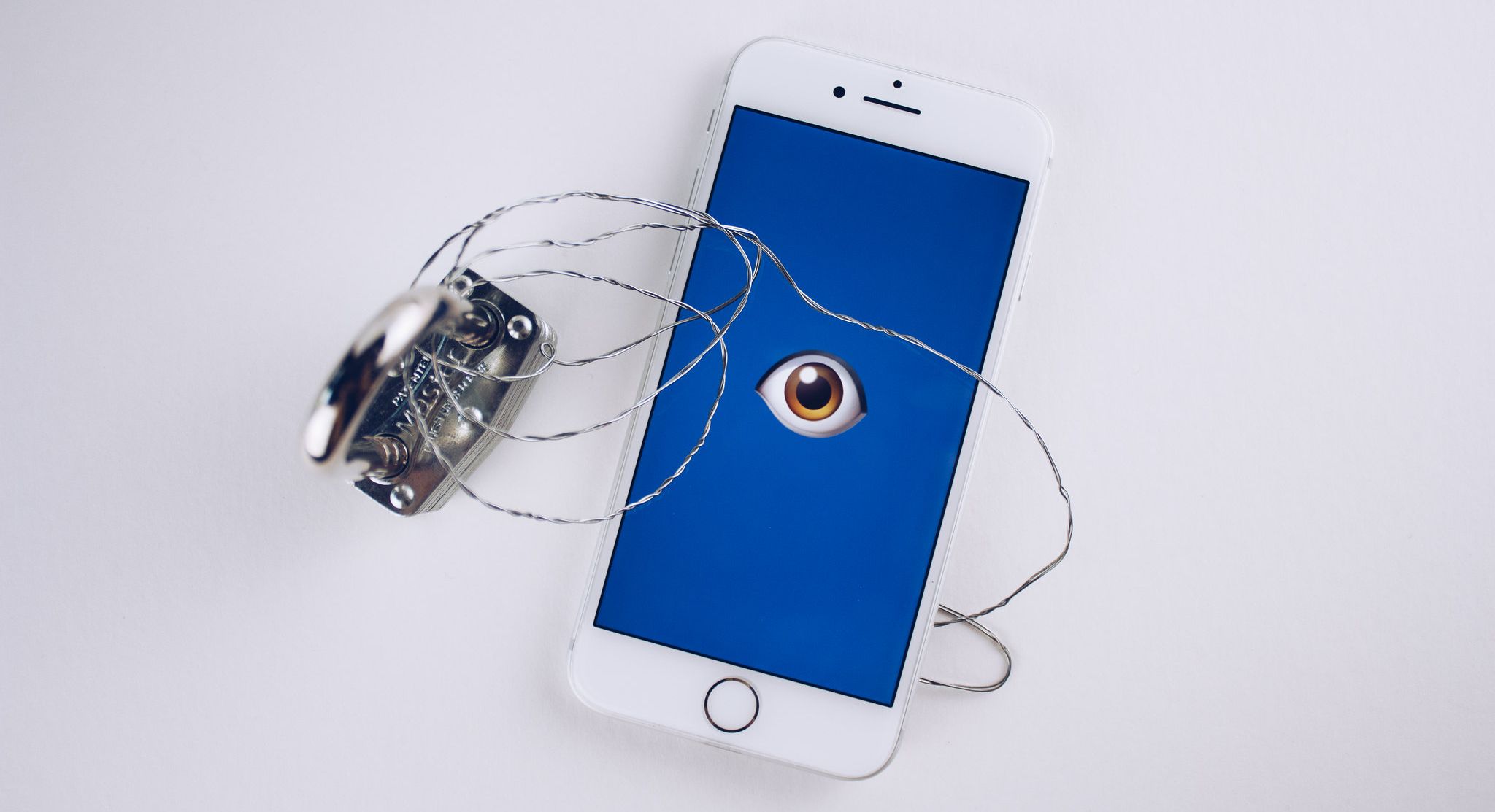 smartphone with eye on screen chained to padlock