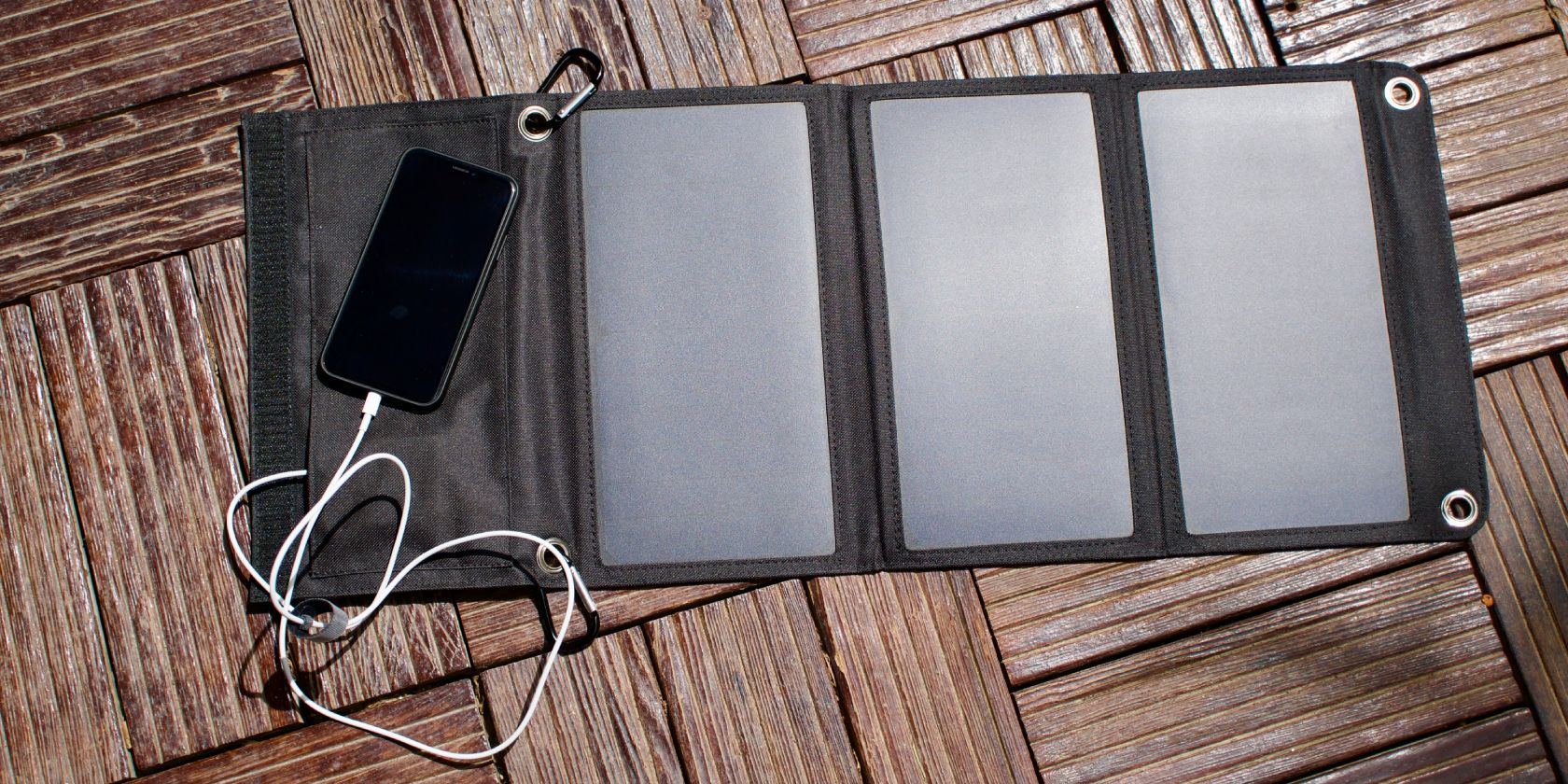Smartphone resting on solar charger