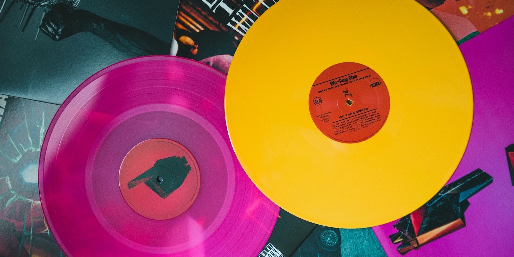 Colorful records laying on a table.