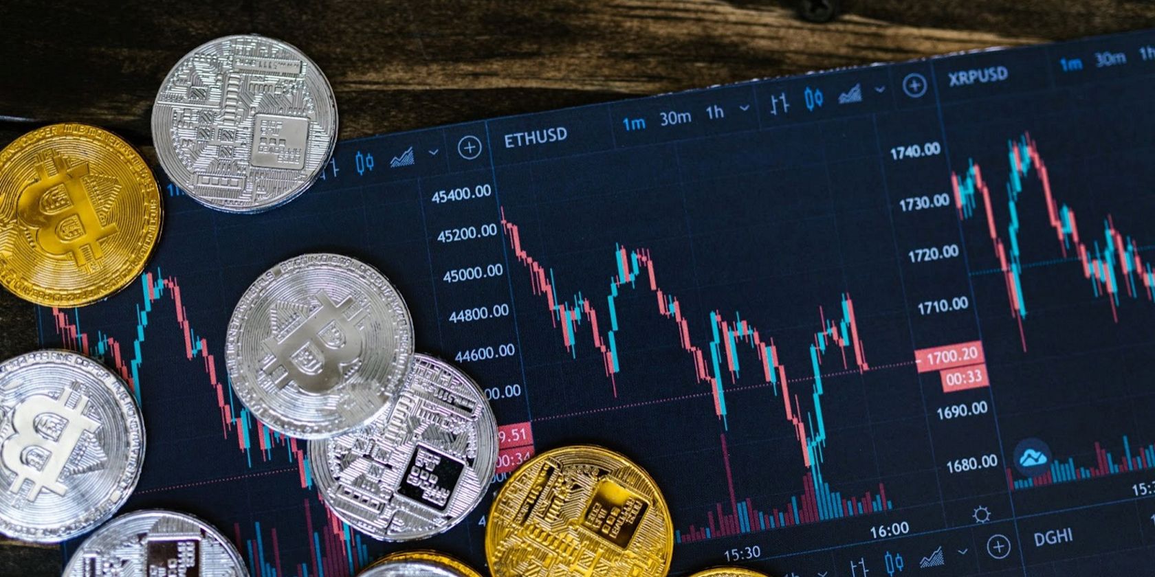 Silver and gold cryptocurrencies with the background of a crypto chart