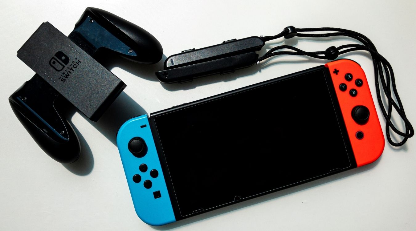 A photograph of a standard Nintendo Switch console with red and blue Joy Cons