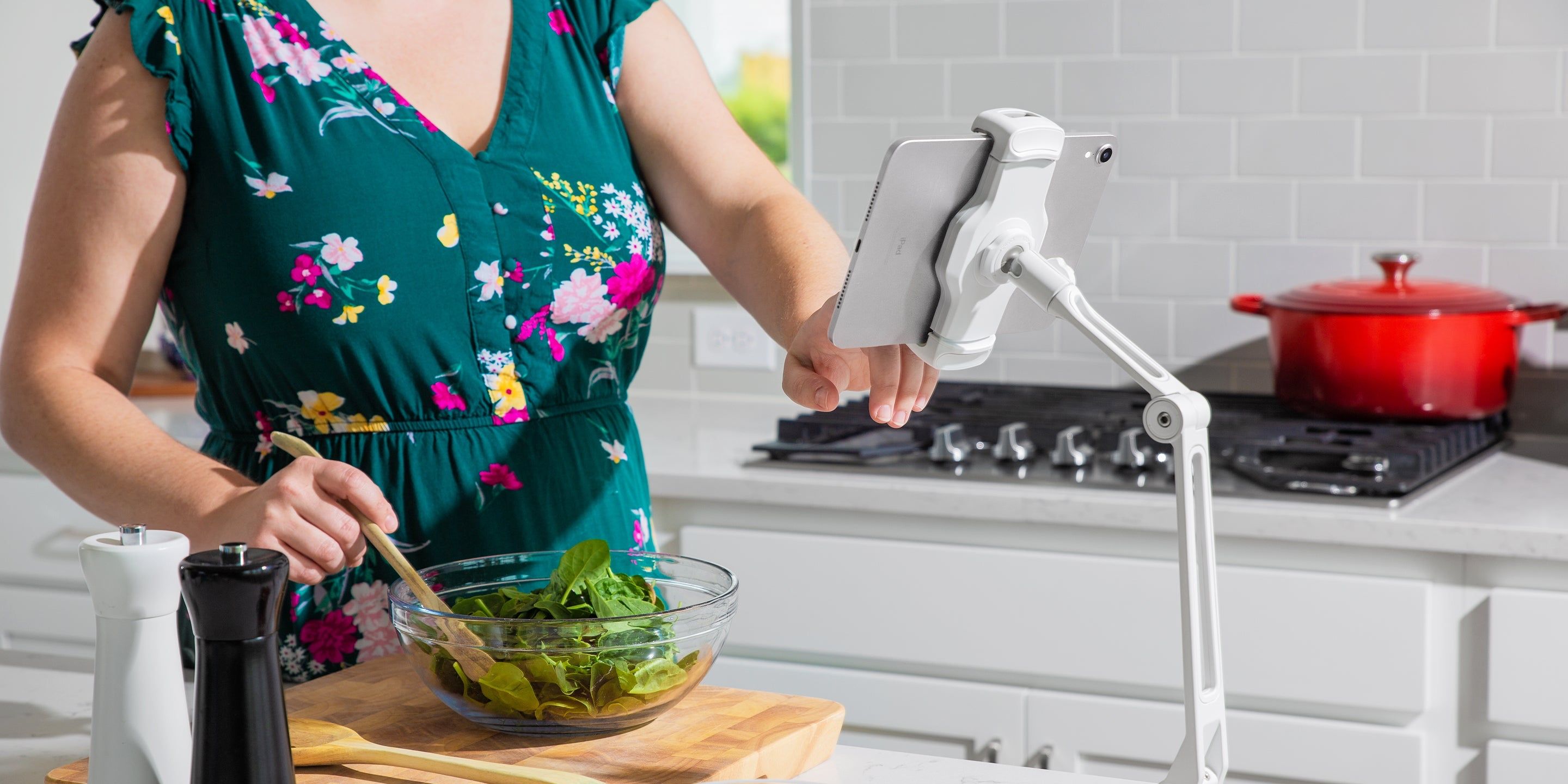 Woman using her iPad in the kitchen with Twelve South's HoverBar Duo stand