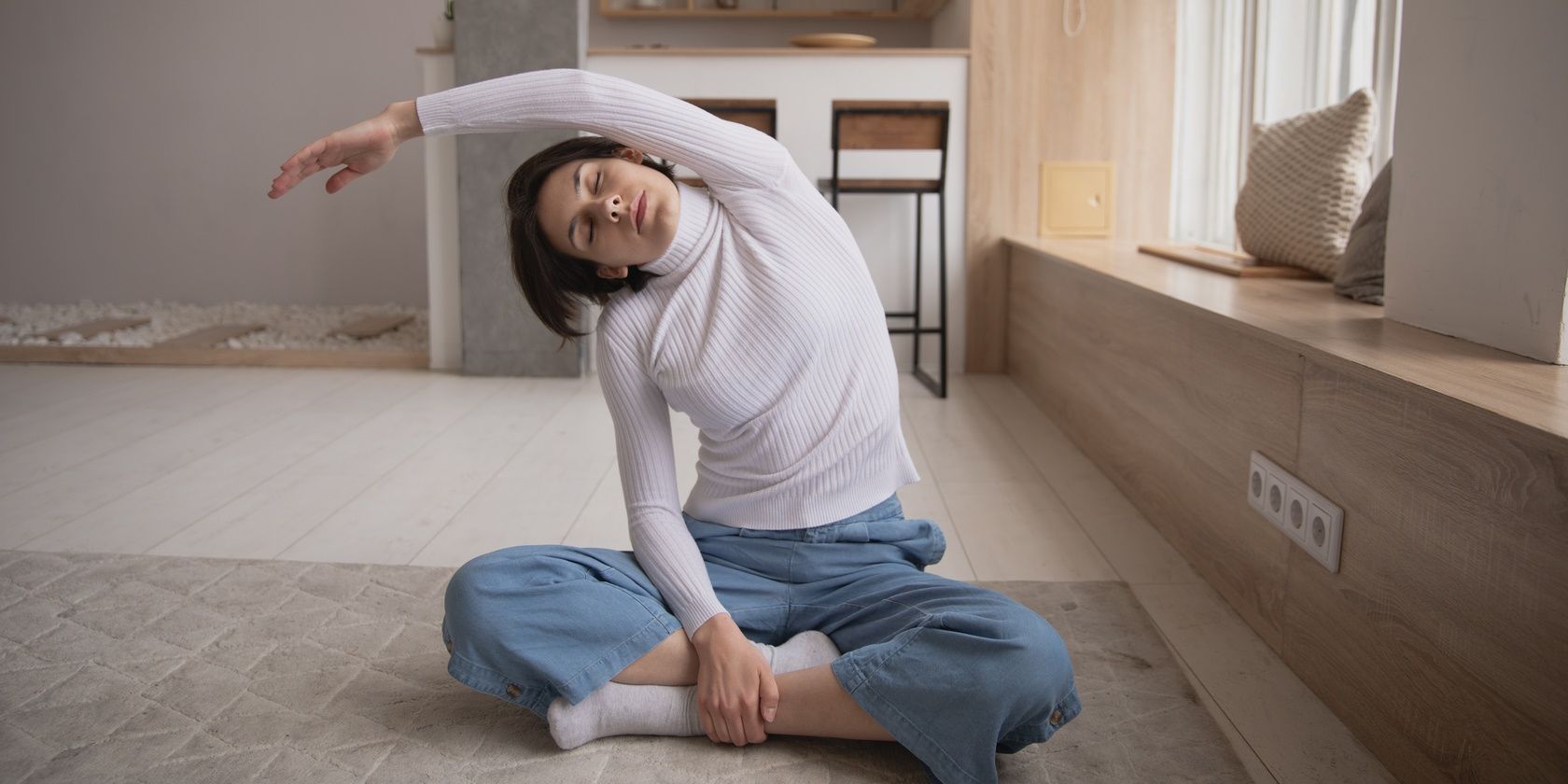 woman sitting on floor and stretching