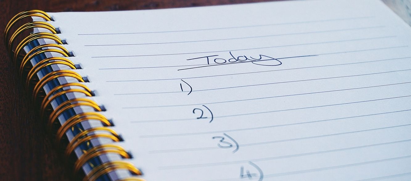A notebook with "Today" written at the top and to-do list numbering beneath it. 