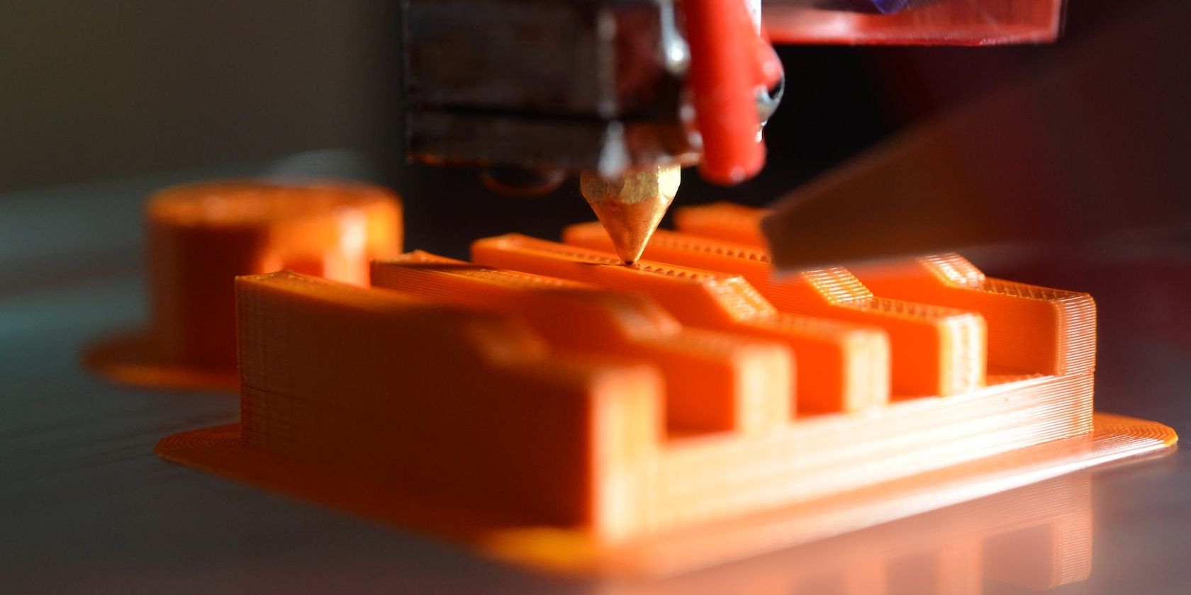 3d printer working on orange print