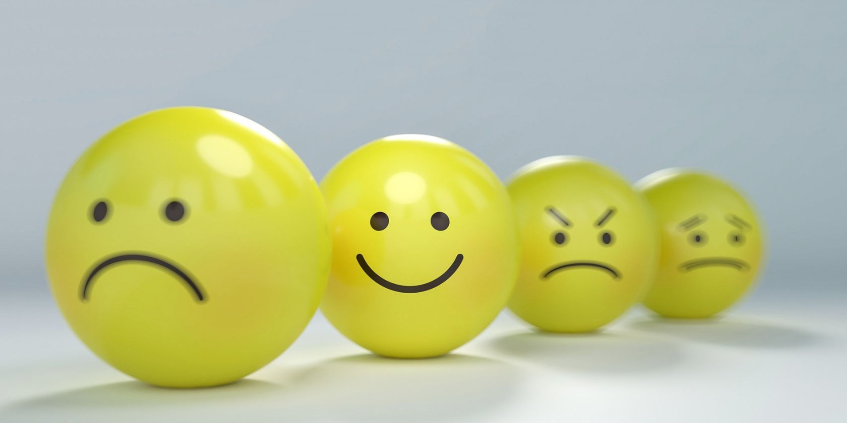 Four yellow balls with different emotions