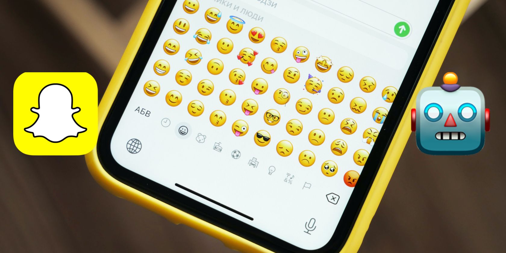 A phone displaying emojis with the Snapchat logo on the left and robot emoji on the right