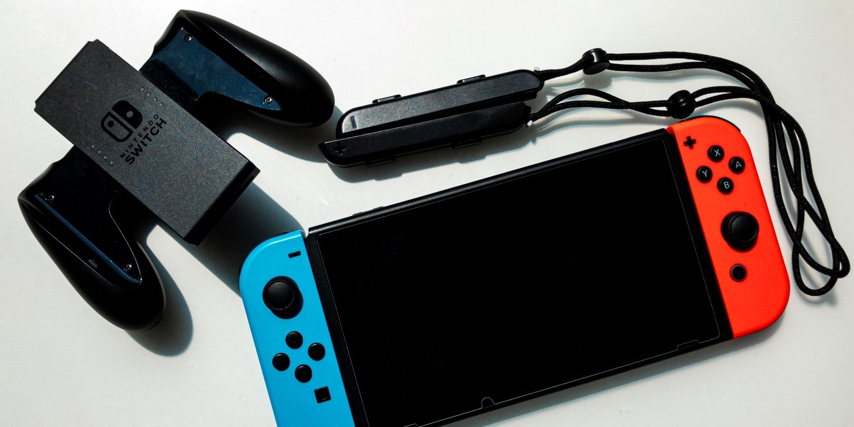 A photograph of a Nintendo Switch with Blue and Red Joy Cons surrounded by accessories