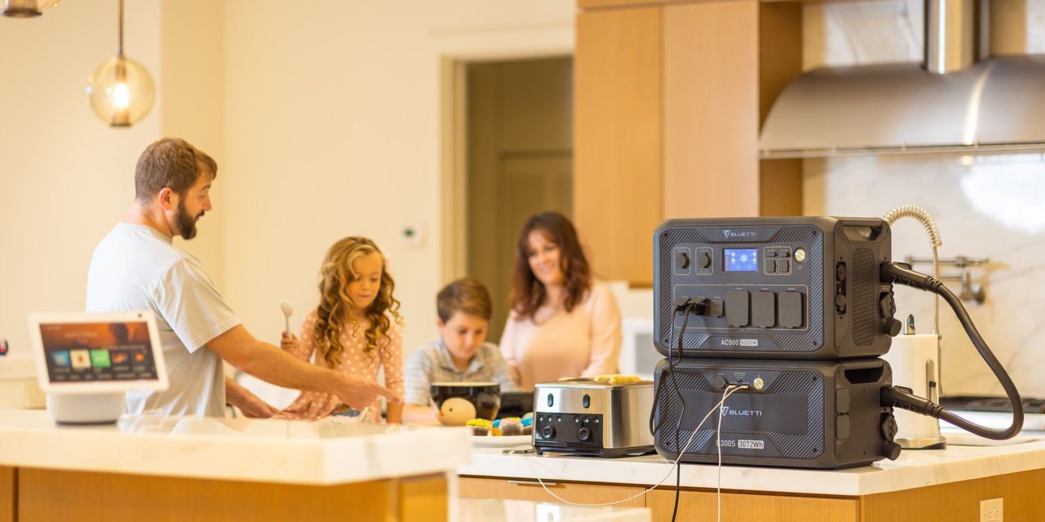 bluetti ac500 and b300s on counter top with family in the background