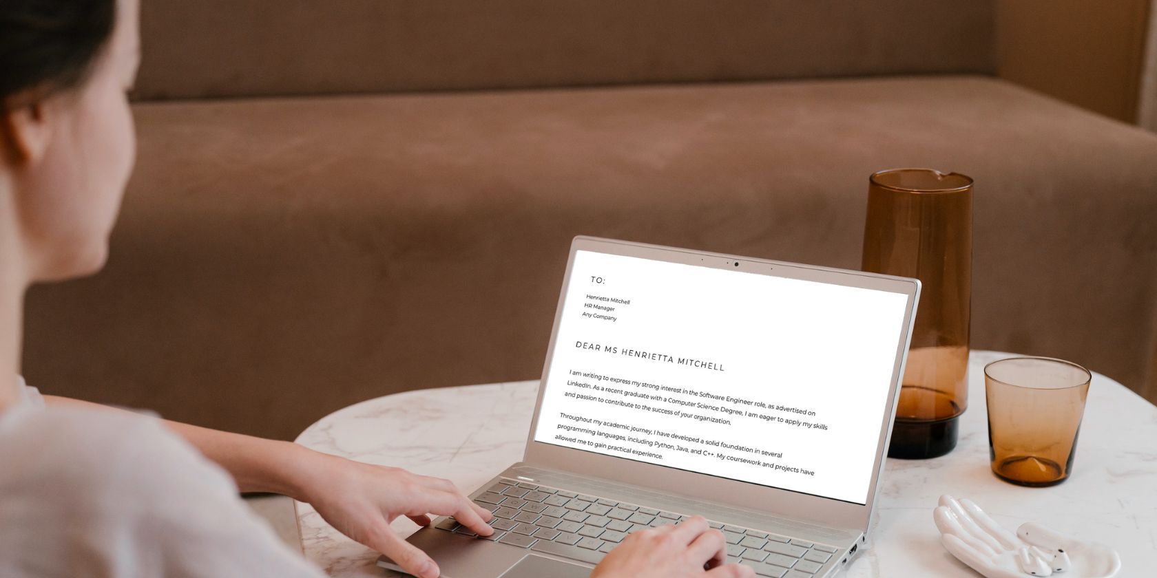 a woman writing a cover letter on her laptop