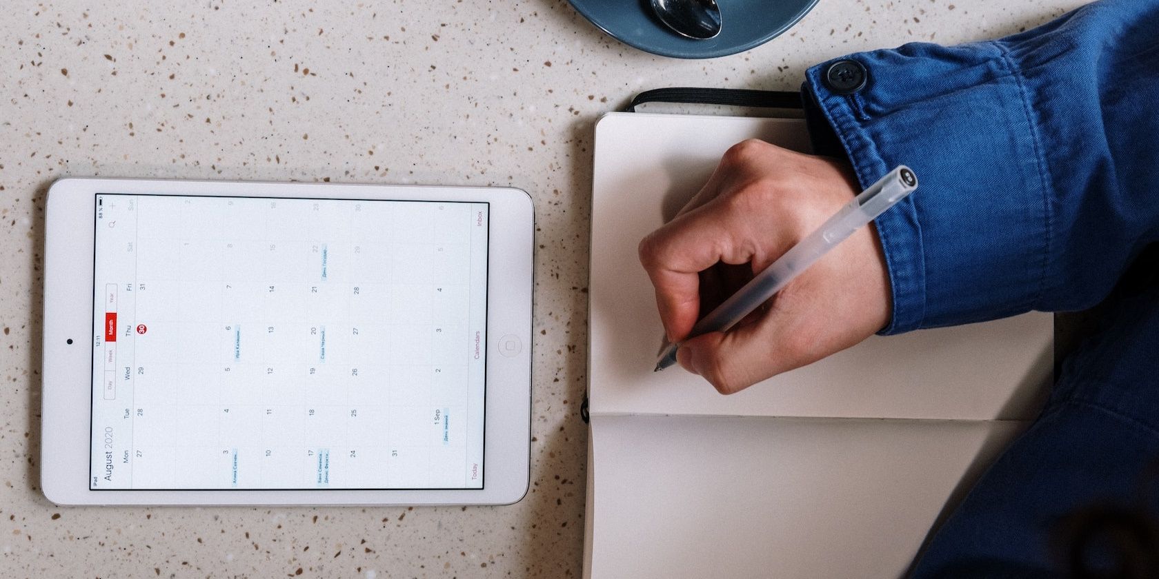 Digital Calendar on surface with blank notebook