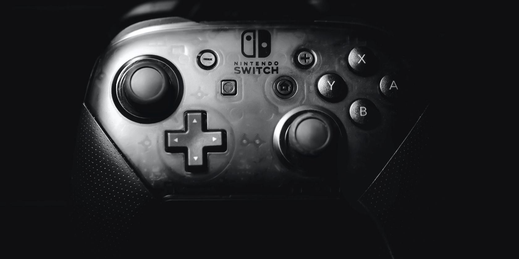 A photograph of a Nintendo Switch Pro Controller in front of a black background 