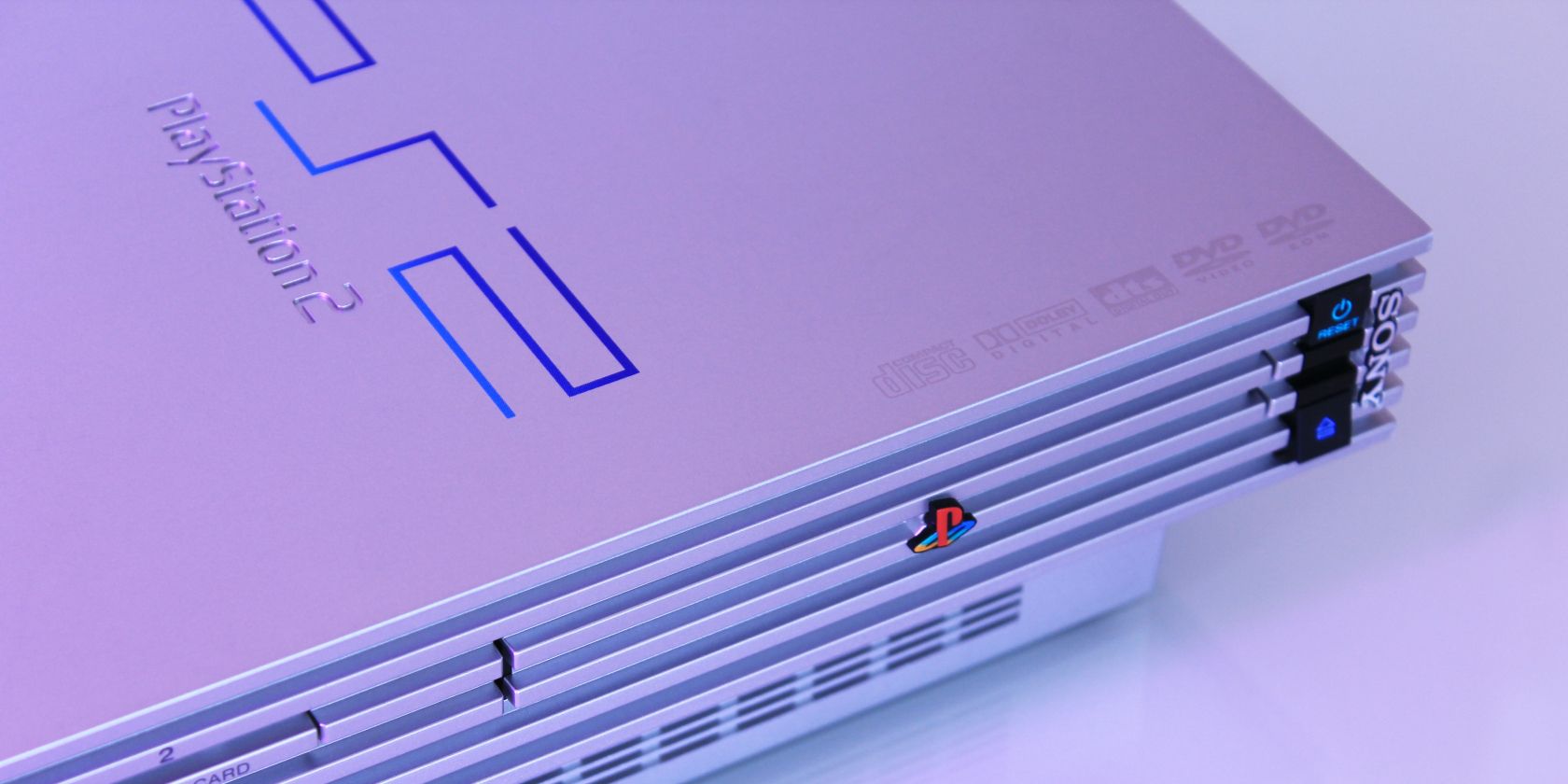 Gray Playstation 2 on a white surface