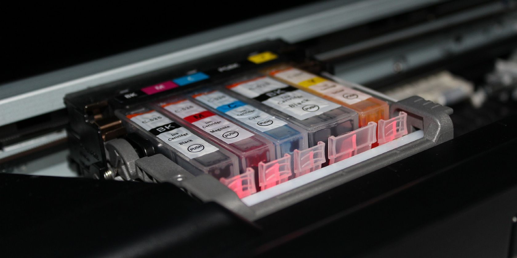 Row of printer ink cartridges inside a printer