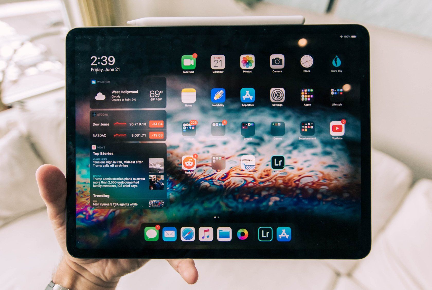 An iPad displaying app icons and widgets on the homescreen