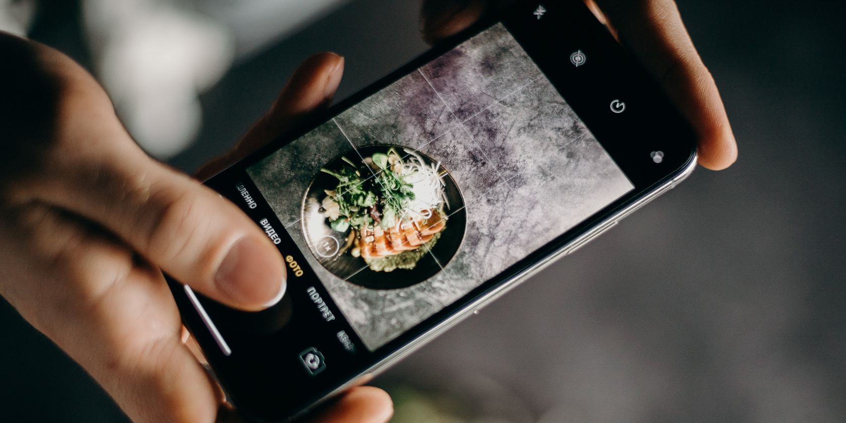 Person taking picture of food using an iPhone