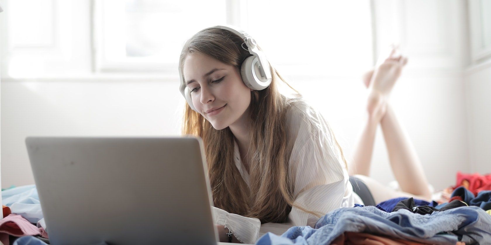 A user listening to music on a laptop 