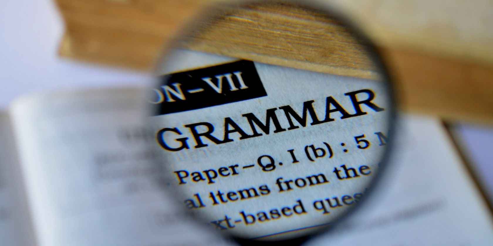 magnifying glass showing word grammar on paper