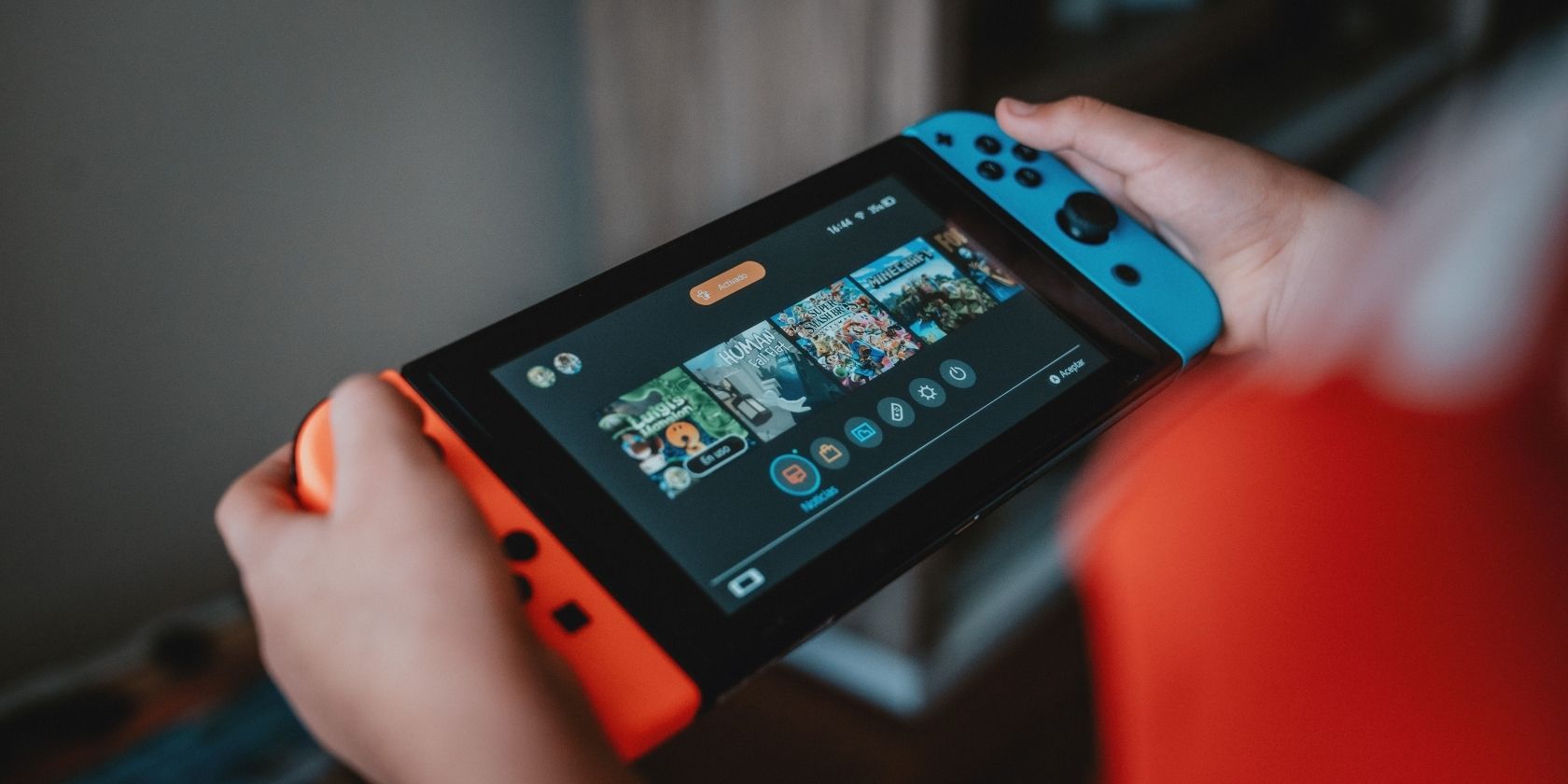 A photograph of someone playing a Nintendo Switch in handheld mode 