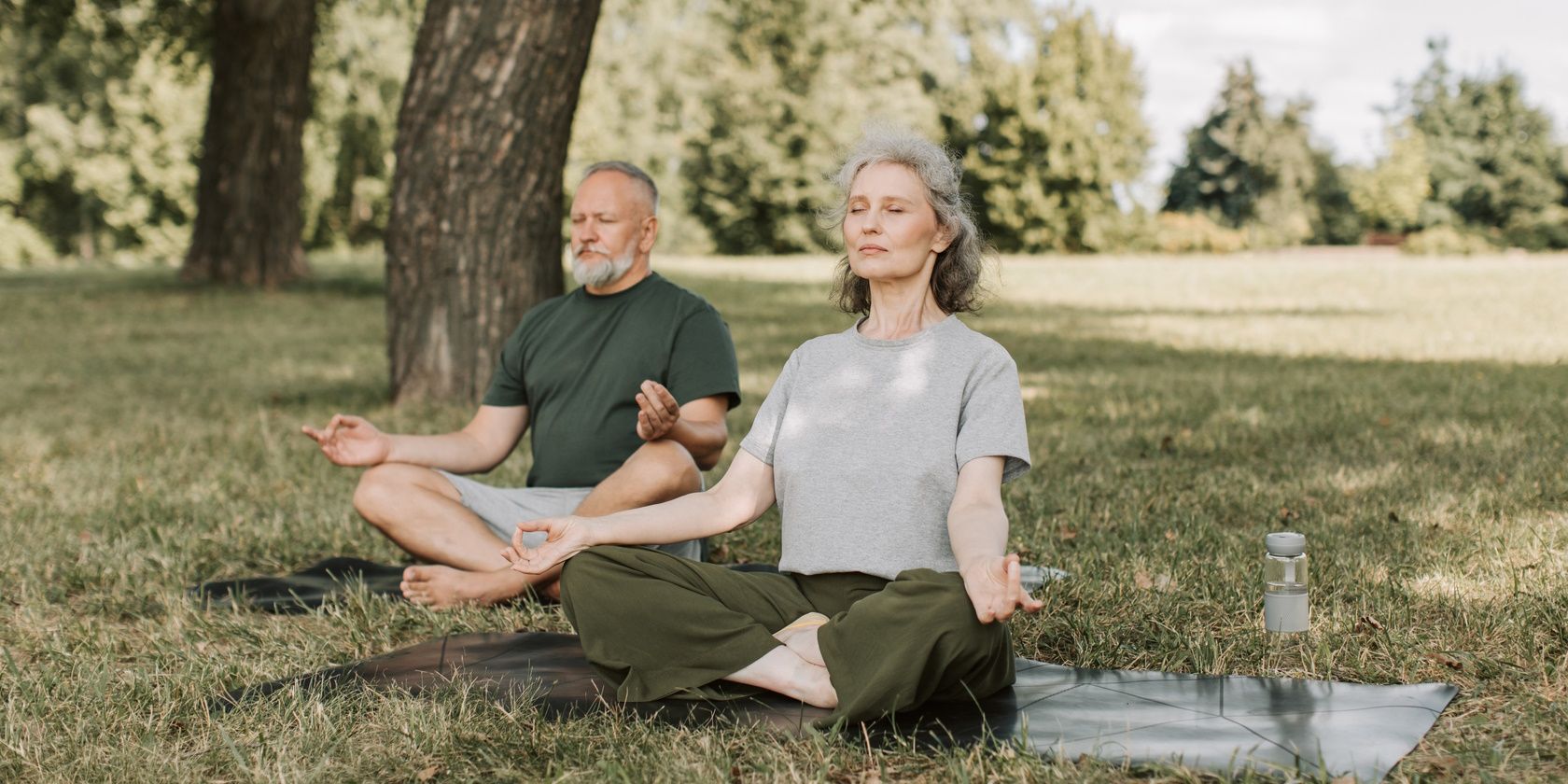 older couple practicing breathing outdoors