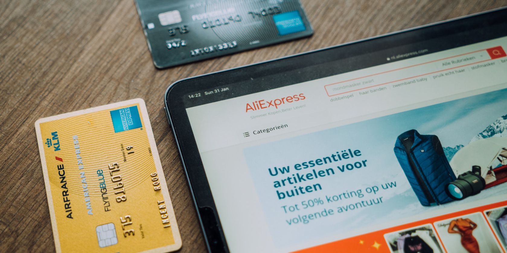 ali express website on a tablet and bank cards