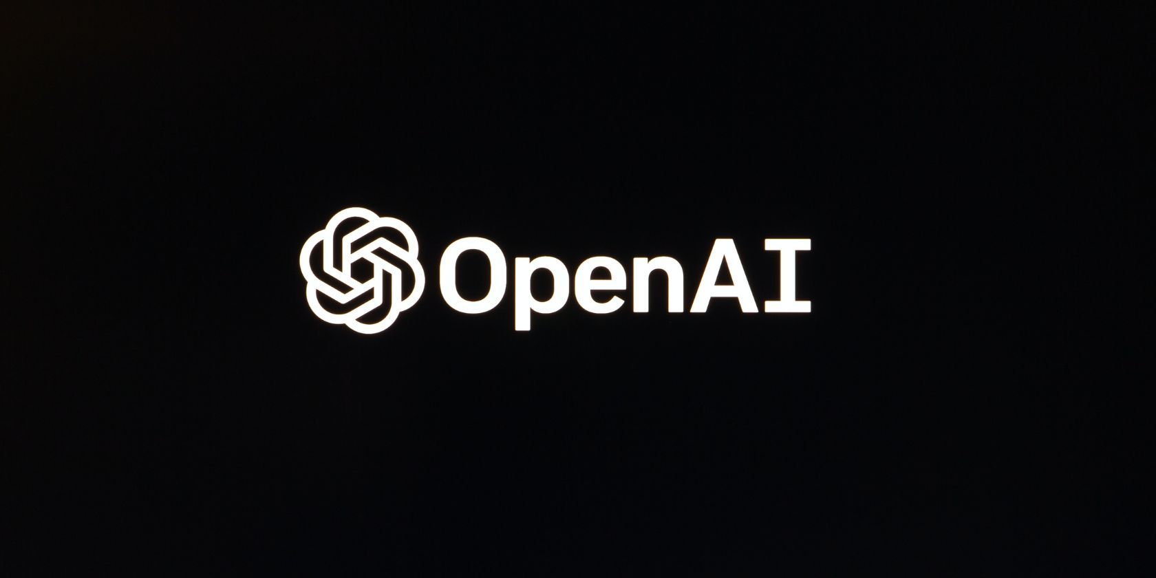 openai logo on black screen