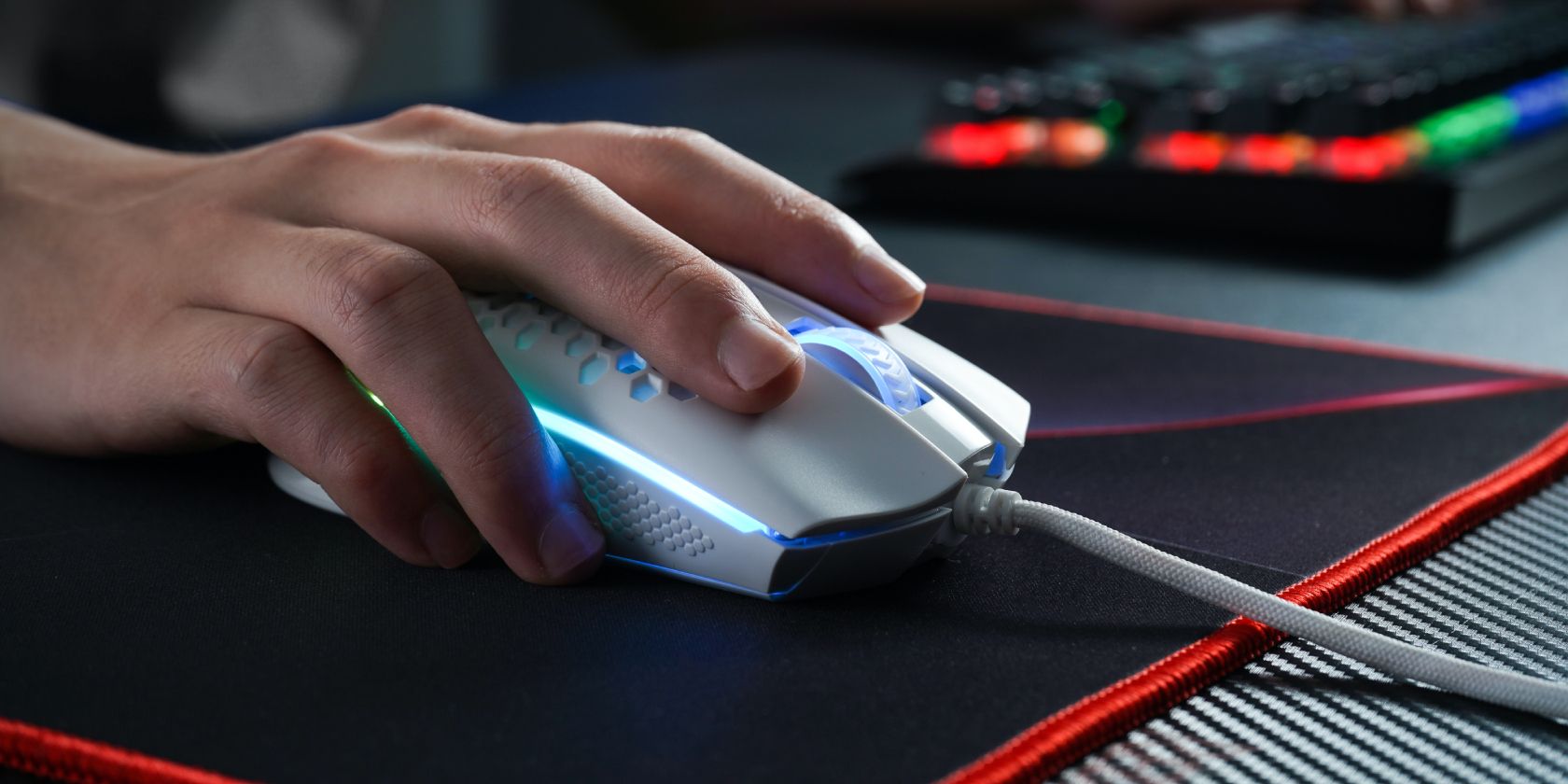 Person using a white gaming mouse