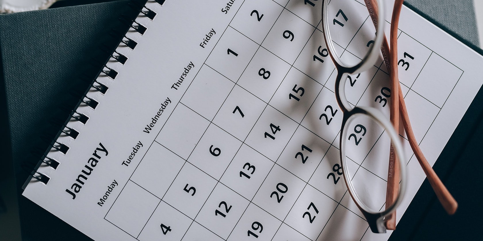 Glasses on top of a calendar
