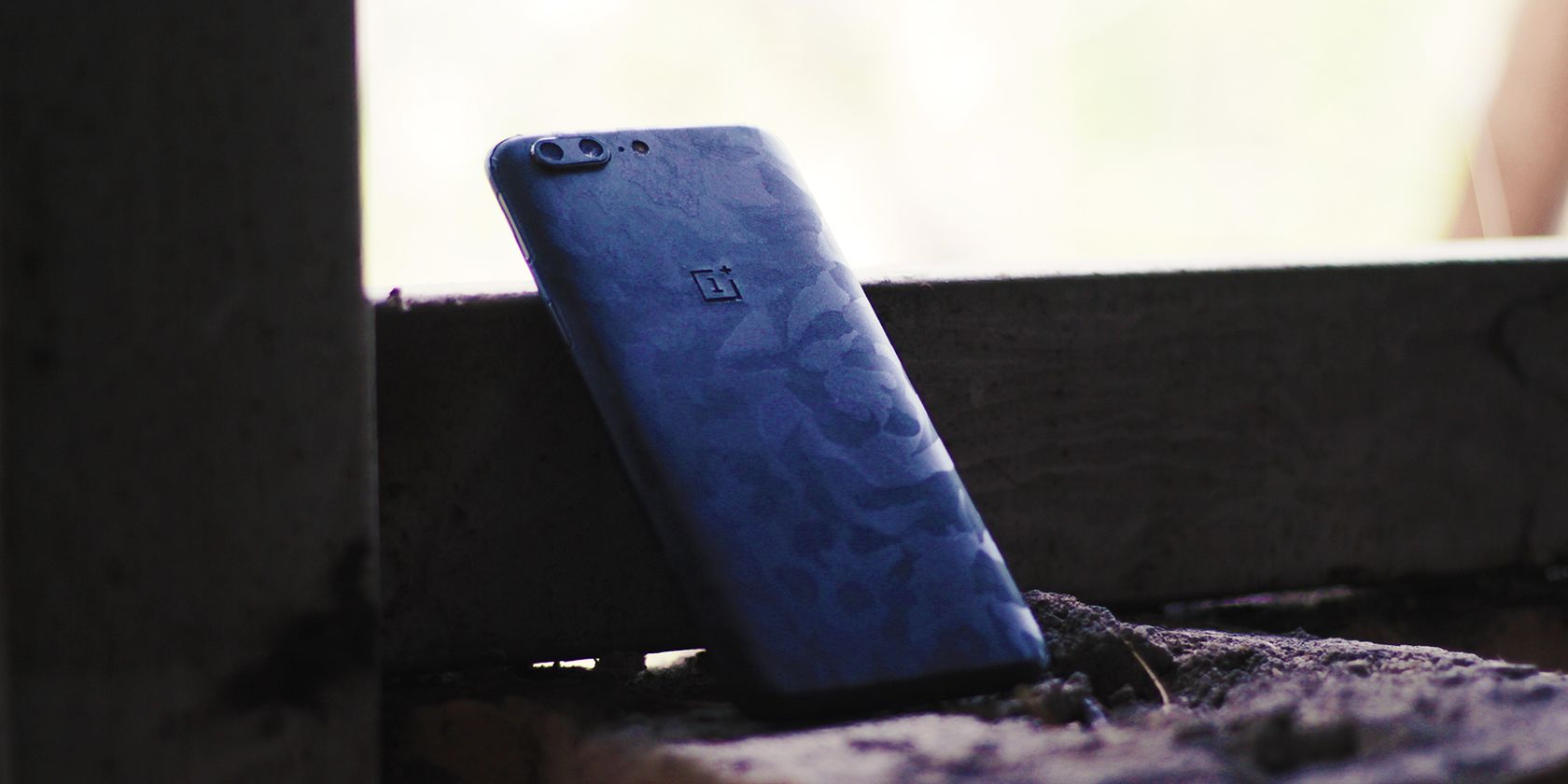OnePlus phone with a black camouflage skin 