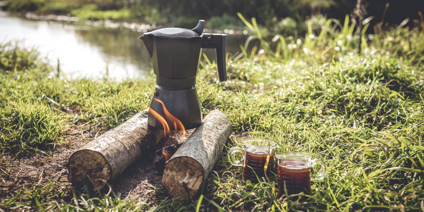 Portable coffee maker over a small campfire