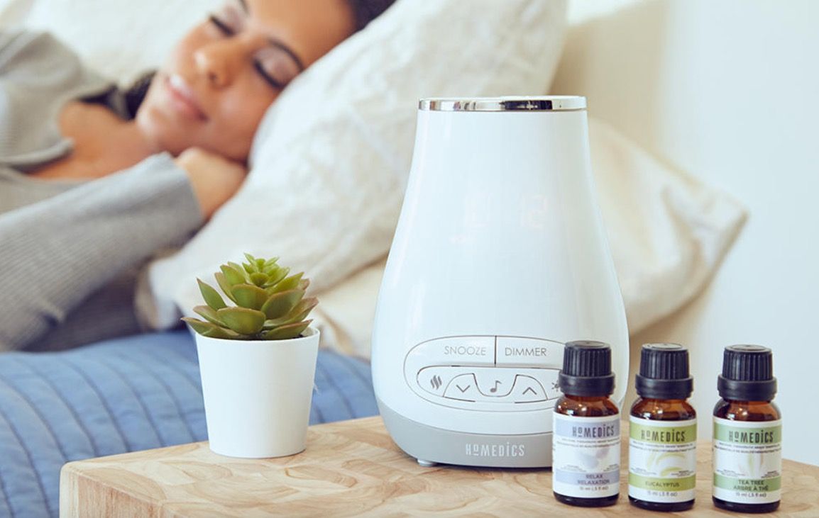 Homedics Aromatherapy Alarm clock next to sleeping person