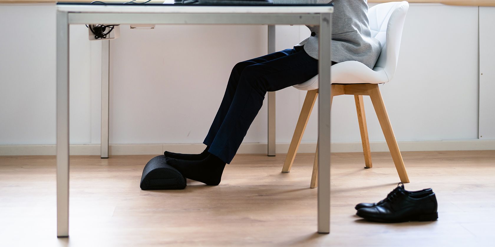 sitting on a chair with the feet resting on a footrest