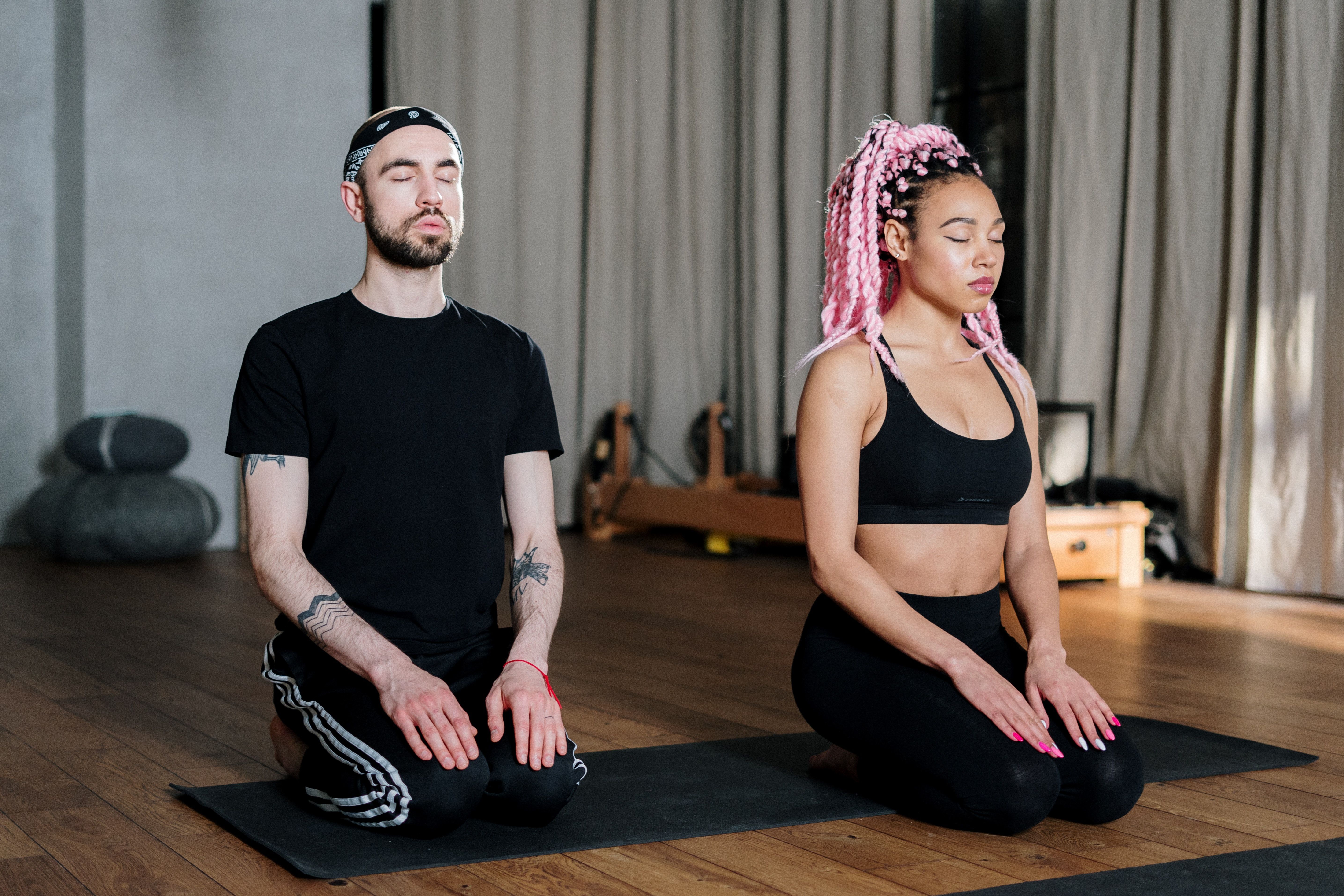 Two people meditating to find calm and ease anxiety