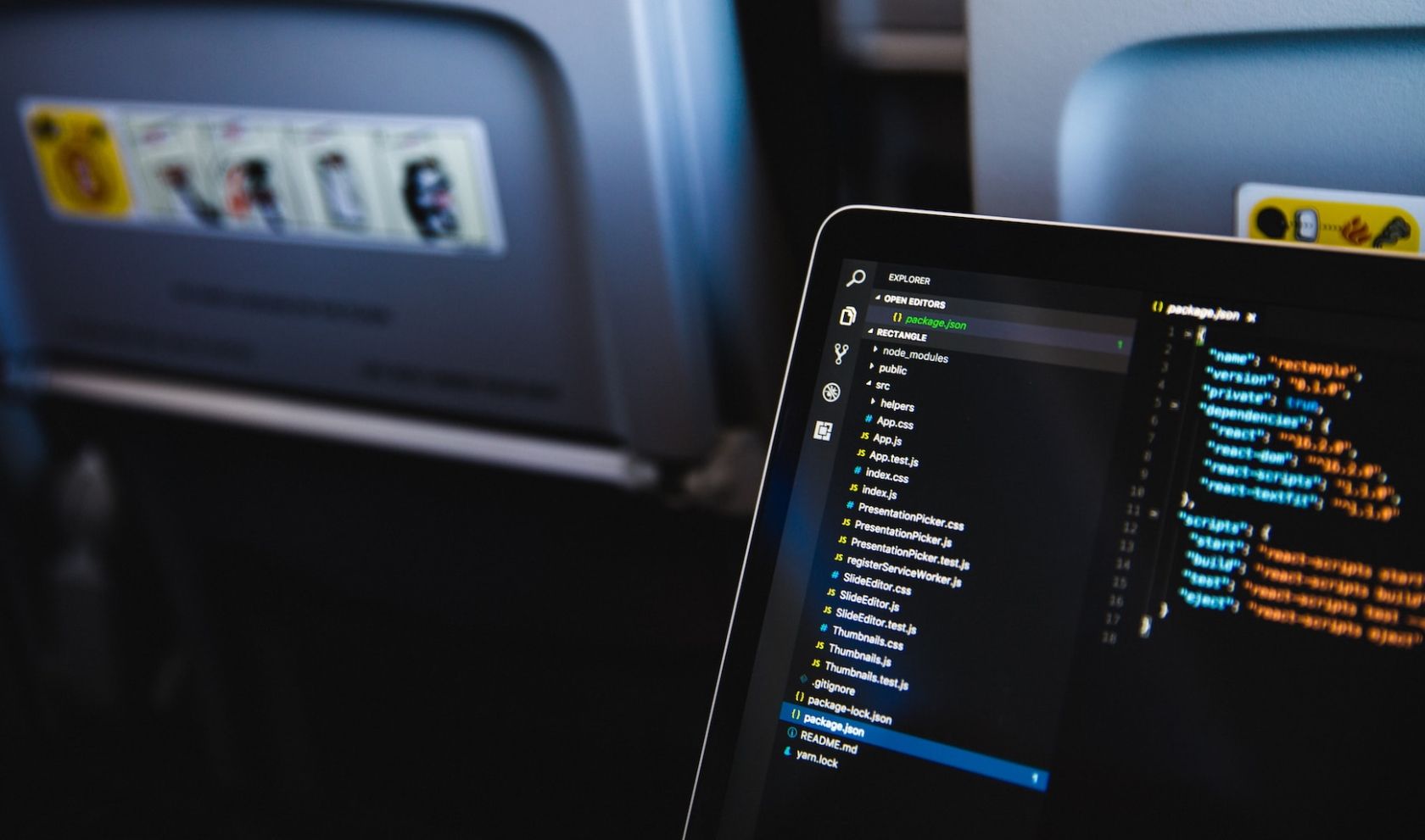 working on a MacBook during a flight