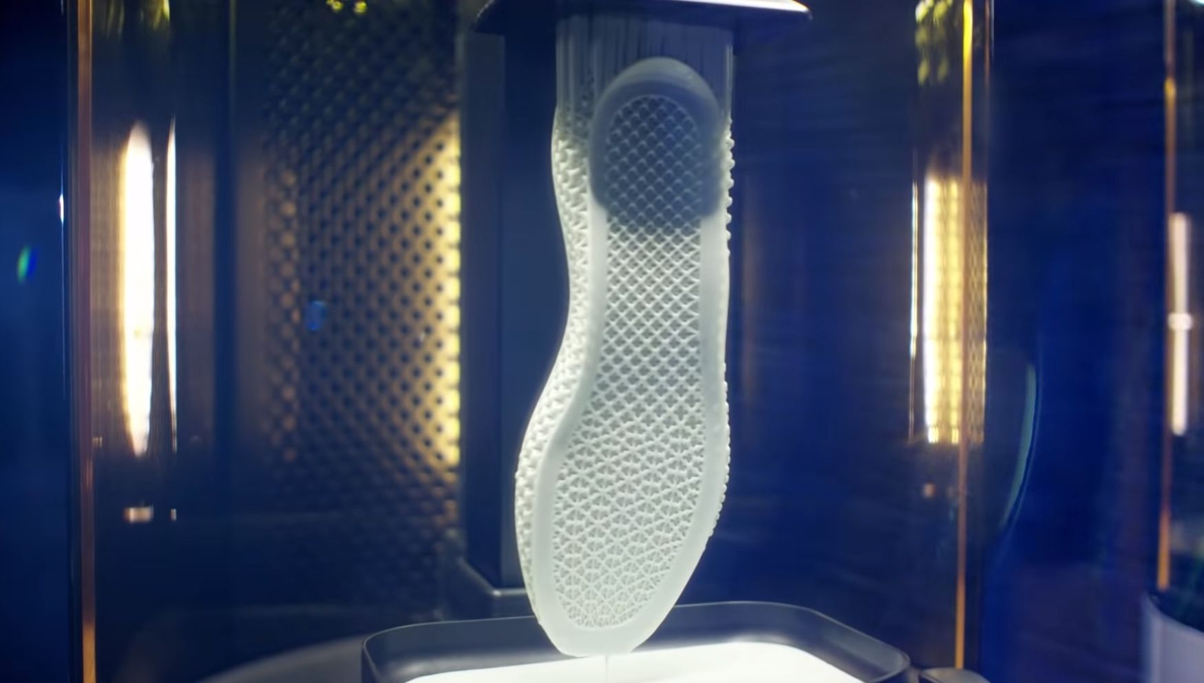 White sole of a shoe being 3D printed in a resin 3D printer