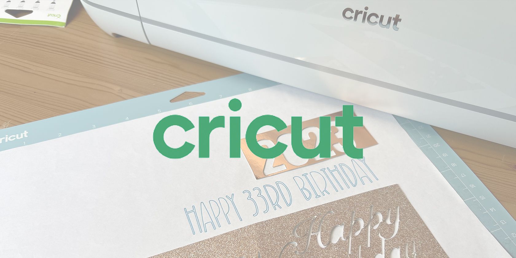 Cricut logo overlaid on Cricut cutting mat and machine.